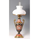 A Victorian stoneware gilt brass mounted pedestal oil lamp, having opaque glass shade,