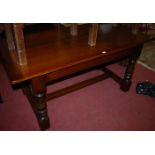 A contemporary oak planked top refectory table, having cleated ends,