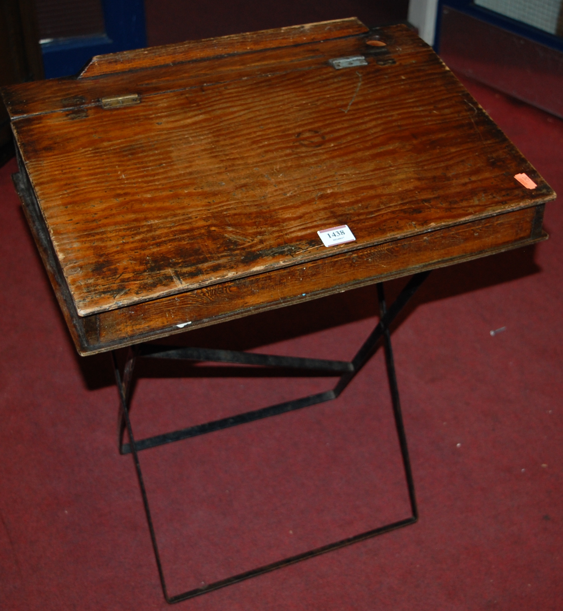 An early 20th century stained pine hinge top folding portable child's school desk