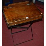 An early 20th century stained pine hinge top folding portable child's school desk