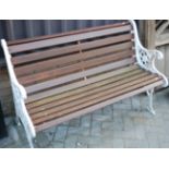 A Victorian style cast iron ended and stained teak slatted two-seater garden bench, w.