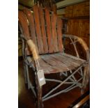 A rustic stained wood armchair,