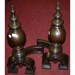 A pair of Baroque burnished cast iron andirons, having curved back supports, h.