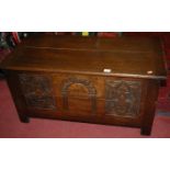 An early 20th century joined and moulded oak hinge top blanket box,