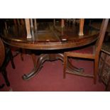 An early Victorian rosewood circular pedestal breakfast table raised on scroll supports, dia.