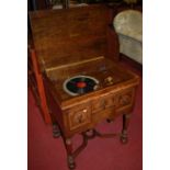 A William & Mary style figured walnut and cross banded hinge top freestanding gramophone, width 67.