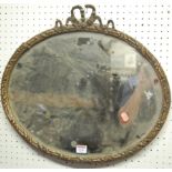 A late 19th century floral gilt decorated bevelled oval wall mirror, w.