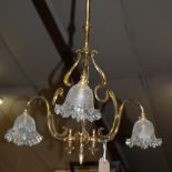 An Art Nouveau lacquered brass three light ceiling pendant,