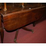 A Regency mahogany pedestal drop leaf supper table having opposing end drawers,