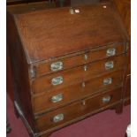 An early 19th century oak slope front four drawer writing bureau,