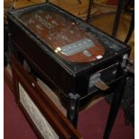 A mid-20th century freestanding ebonised bagatelle table