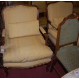 A pair of contemporary French style mahogany open armchairs, having yellow striped upholstery,