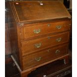 An Edwardian oak and chequer strung slopefront three drawer writing bureau,