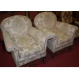 A pair of early 20th century walnut framed and floral re-upholstered armchairs,