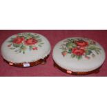 A pair of Victorian walnut circular floral embroidered low footstools