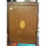 An Edwardian mahogany and satinwood inlaid single door hanging wall cupboard