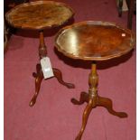 A pair of reproduction walnut and figured walnut piecrust low pedestal occasional tables