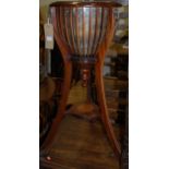 A reproduction mahogany circular plant stand,