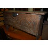 A late 17th century line carved oak six plank blanket box having a chip carved edge,