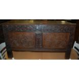 A circa 1700 and later low relief carved twin panelled hinge-top coffer, w.