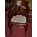 An early 20th century walnut stickback tub elbow chair