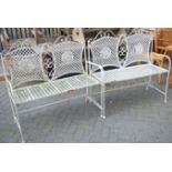 A pair of Regency style white painted wrought metal two-seater garden benches, w.