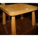A contemporary elm round cornered low stool