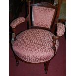 A late Victorian walnut and pink floral upholstered low tub open armchair