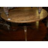 An early 19th century oak pedestal low circular occasional table (reduced in height)