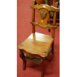 A Victorian walnut metamorphic chair, the splatback with raised shield crest,