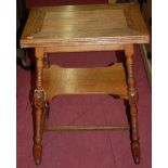 An Edwardian oak fold-over tea table, having revolving action, central platform,