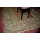 A Caucasian woollen cream ground rug, having geometric stylised ground,