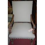 A Louis XVI style carved walnut framed and studded upholstered open armchair