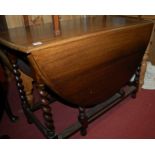 A 1920s oak barleytwist dropleaf dining table,