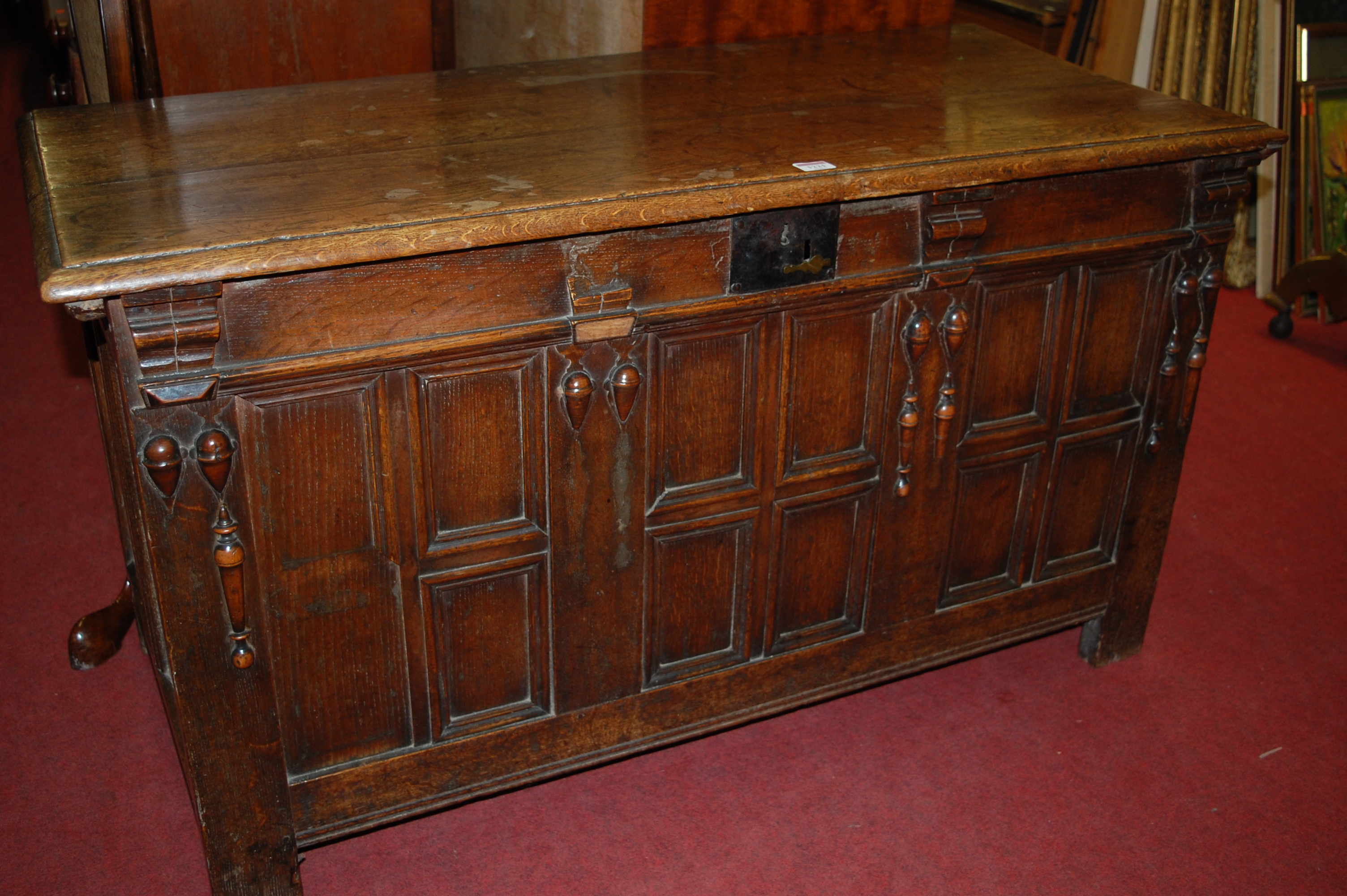 An early 18th century joined oak coffer, having a two-plank top on replacement ironstrap hinges,