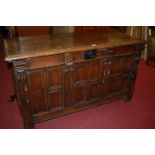 An early 18th century joined oak coffer, having a two-plank top on replacement ironstrap hinges,