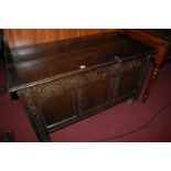 A circa 1700 joined oak three panel coffer, having loop hinges above rosette carved frieze,