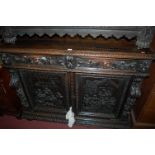 A late 19th century Flemish heavily carved oak double door side cupboard,
