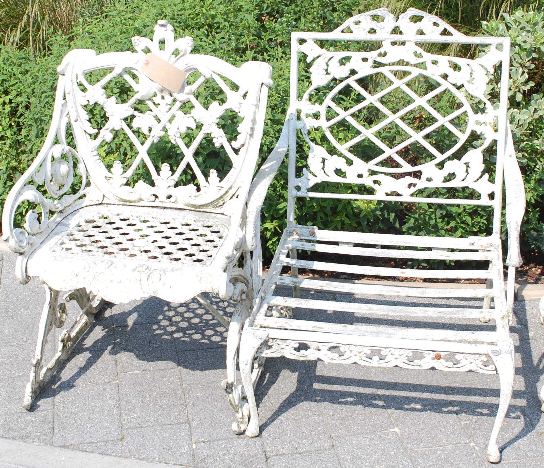 A Victorian style white painted cast metal garden elbow chair,