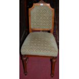 A set of four late 19th century French walnut and green upholstered pad back and seat dining chairs