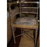 An Edwardian mahogany and satinwood strung rush seat corner chair