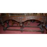 An antique joined and low relief carved oak planked top hall table, of long proportions,