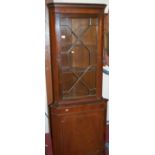 A reproduction mahogany freestanding corner cupboard,