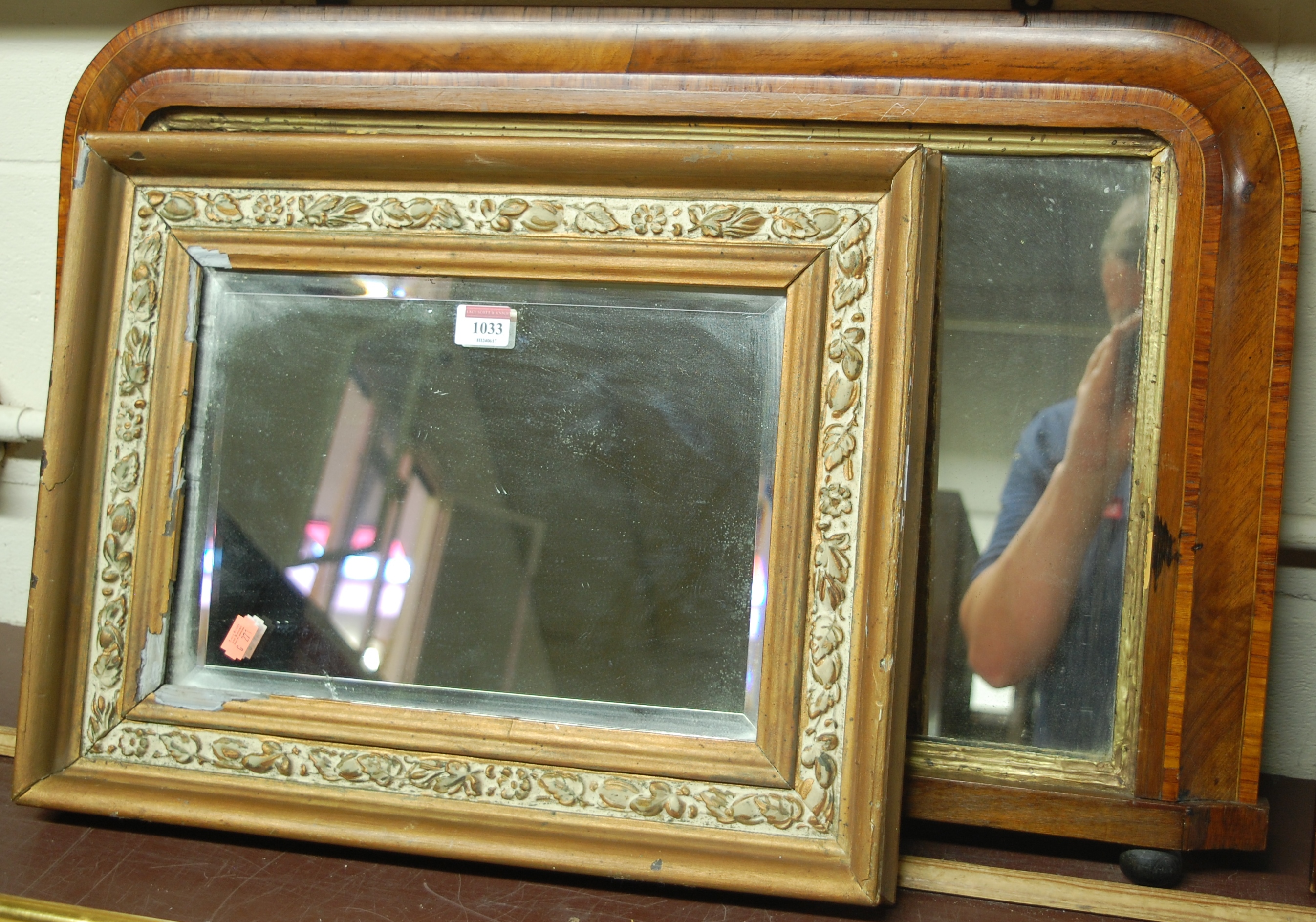 A gilt framed and bevelled wall mirror;