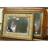 A gilt framed and bevelled wall mirror;