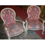 A pair of Victorian painted and pink floral buttonback upholstered open armchairs