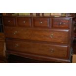 A pair of Stag Minstrel low chests of four short and two long drawers