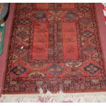 A small Persian woollen red ground Bokhara rug,