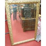 A reproduction gilt framed and bevelled wall mirror,