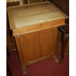 An early 20th century elm hinged slopefront clerks desk,